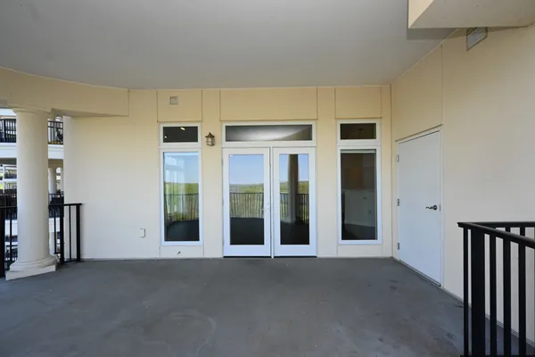 a view of a swimming pool with a bench in front of building