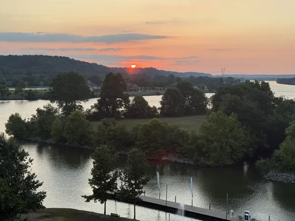 a living room with furniture and a view of kitchen