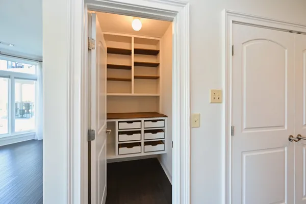 a view of walk in closet with empty racks