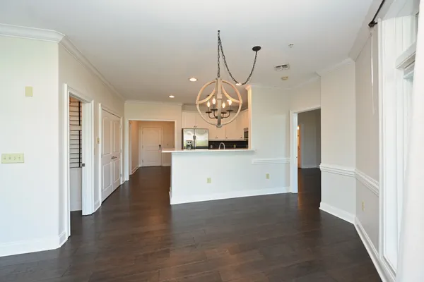 a view of a kitchen with wooden floor and a ceiling fan