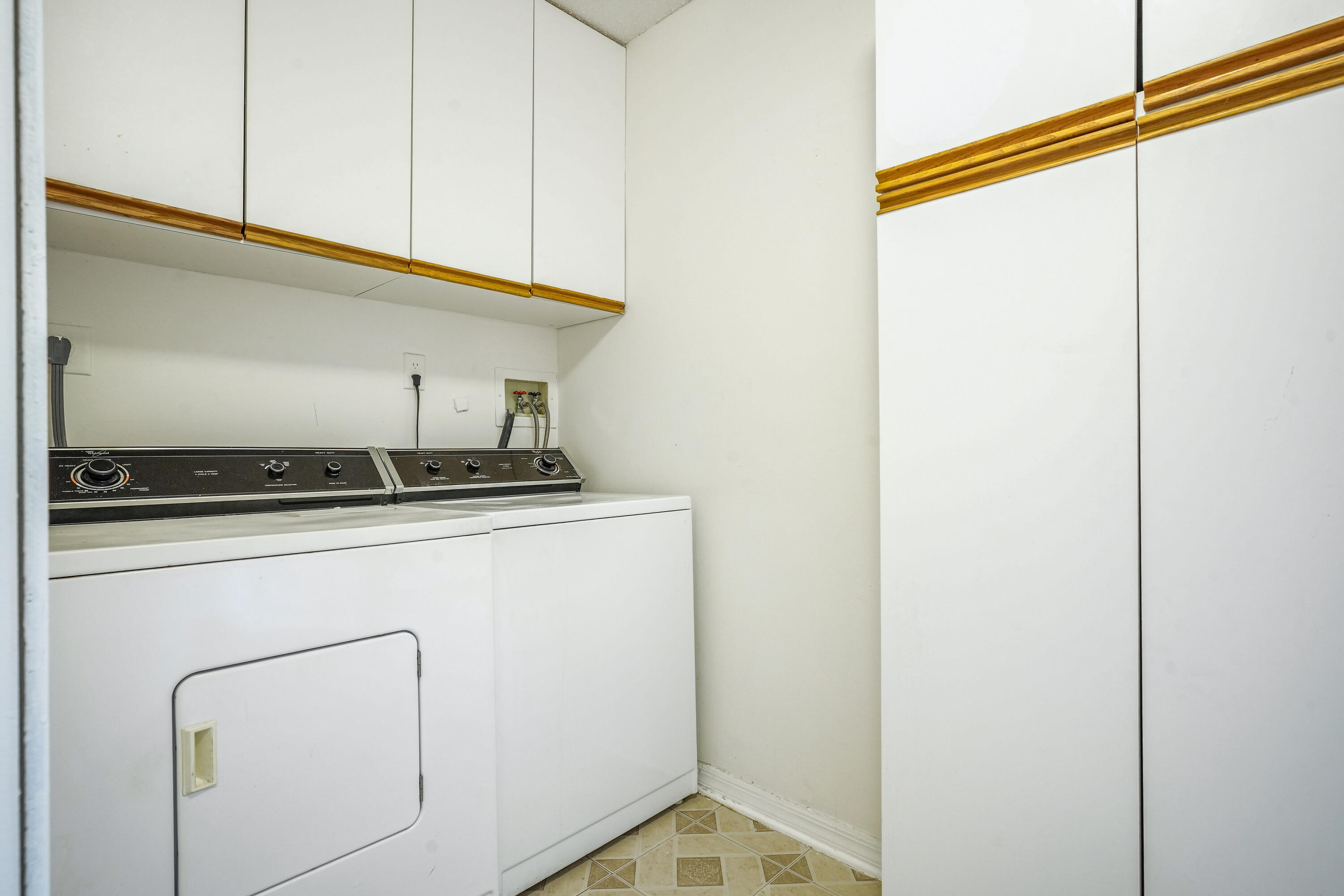 10910 Lakemore Lane, Unit 201 Boca Raton, FL 33498 - Photo 20 of 67 a close view of a utility room with washer and dryer