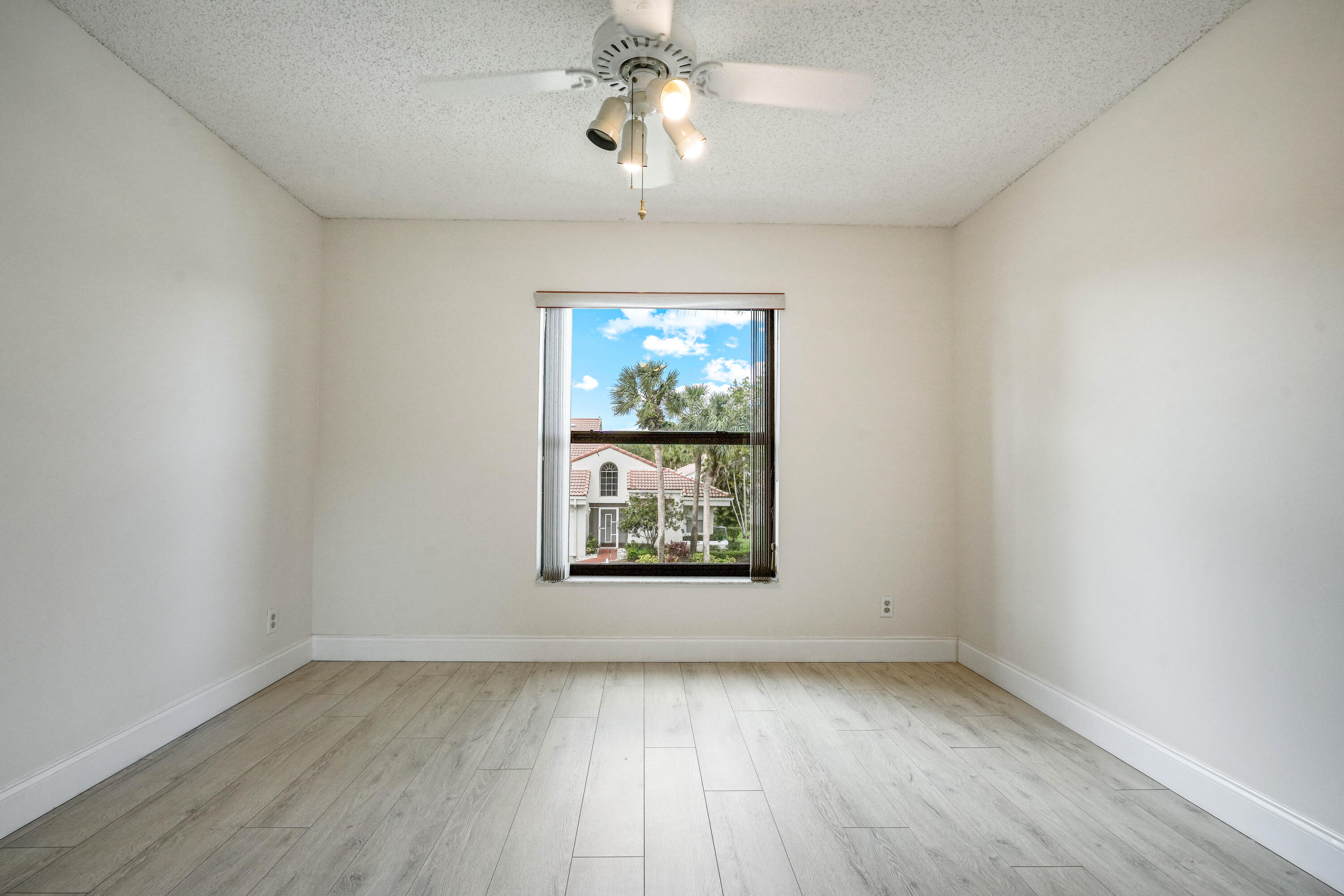 10910 Lakemore Lane, Unit 201 Boca Raton, FL 33498 - Photo 33 of 67 wooden floor in an empty room with a window