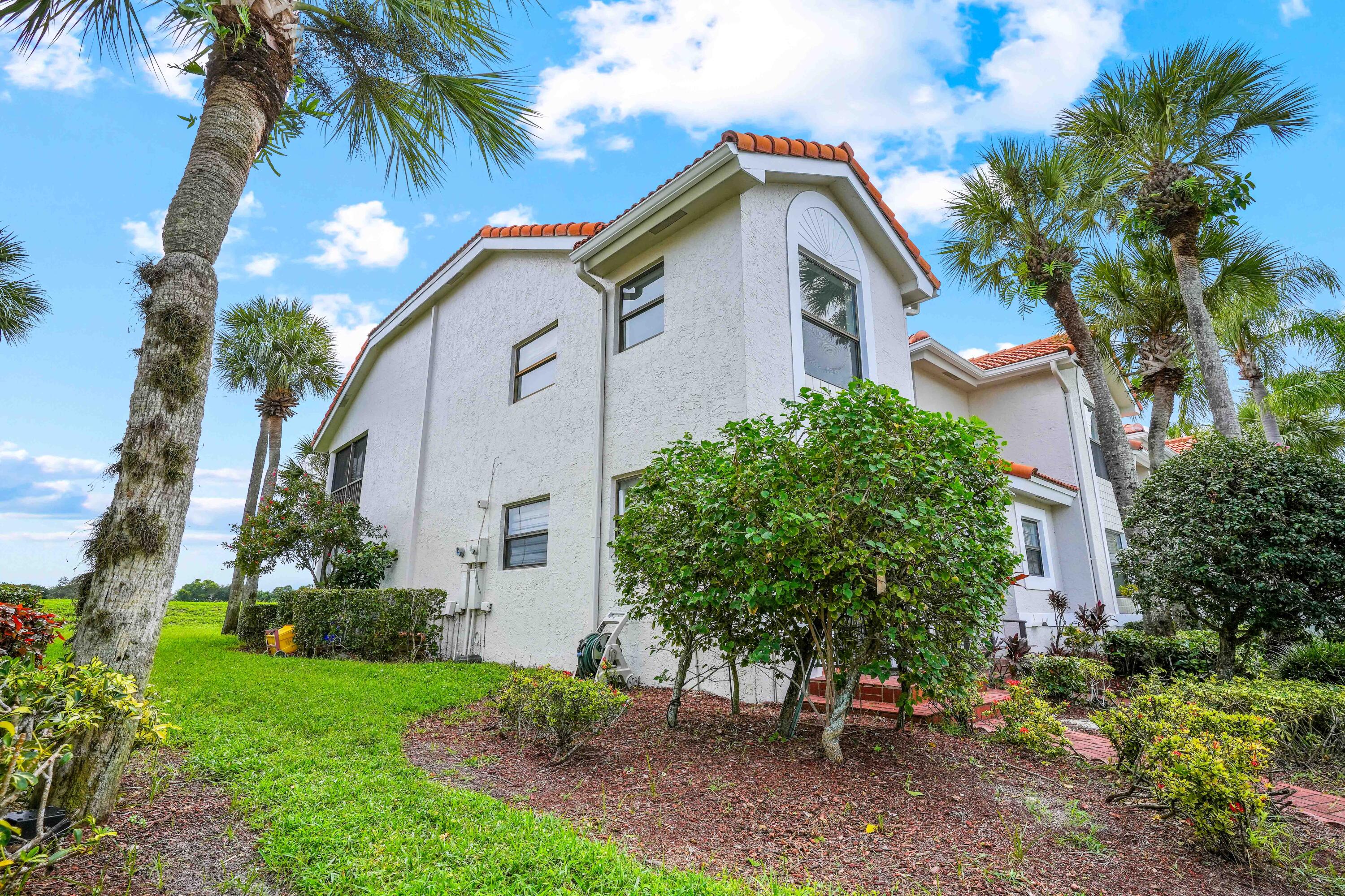 10910 Lakemore Lane, Unit 201 Boca Raton, FL 33498 - Photo 4 of 67 a view of a house with a yard