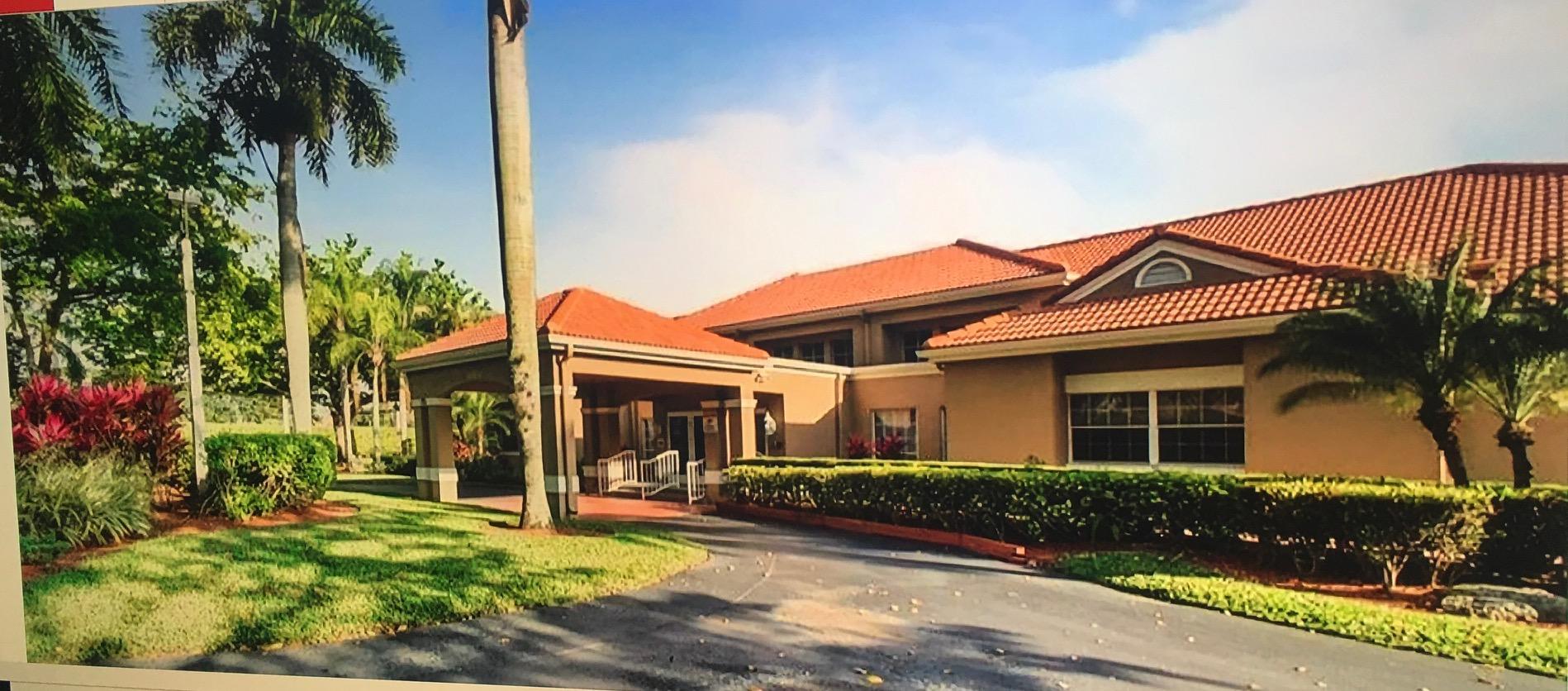 10910 Lakemore Lane, Unit 201 Boca Raton, FL 33498 - Photo 41 of 67 front view of a house with a yard