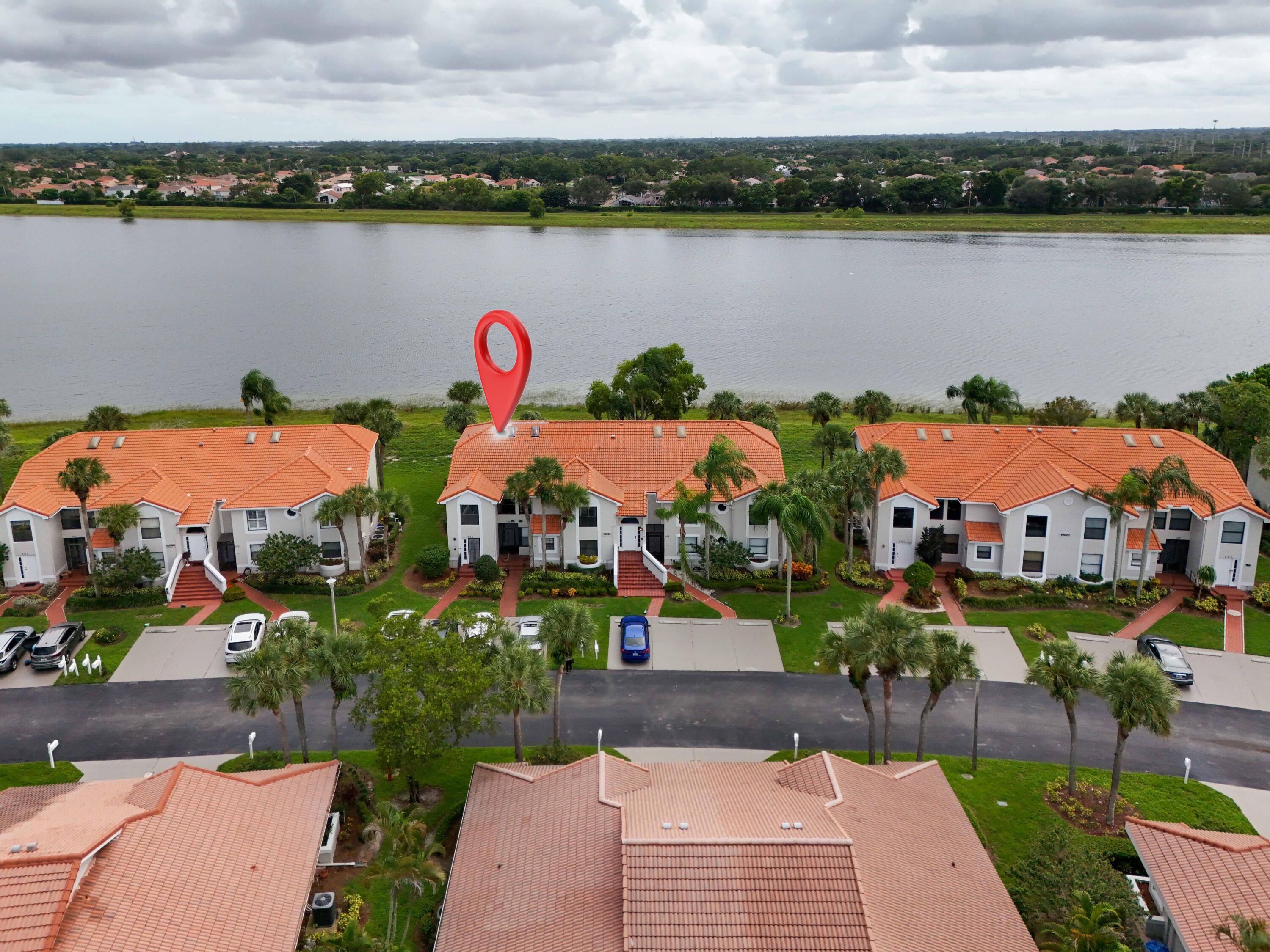 10910 Lakemore Lane, Unit 201 Boca Raton, FL 33498 - Photo 47 of 67 an aerial view of lake and houses with outdoor space