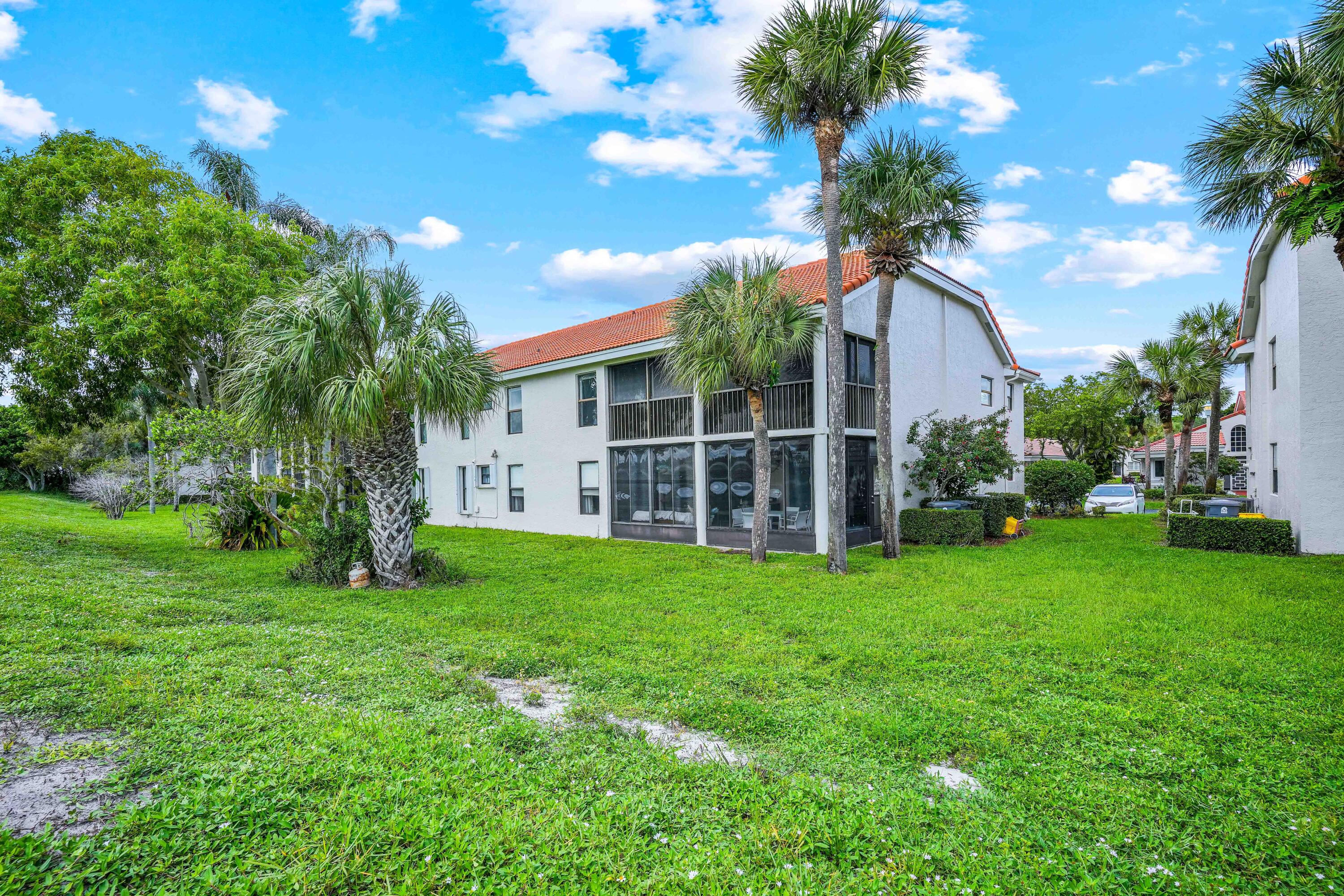 10910 Lakemore Lane, Unit 201 Boca Raton, FL 33498 - Photo 5 of 67 a view of a house with backyard and garden