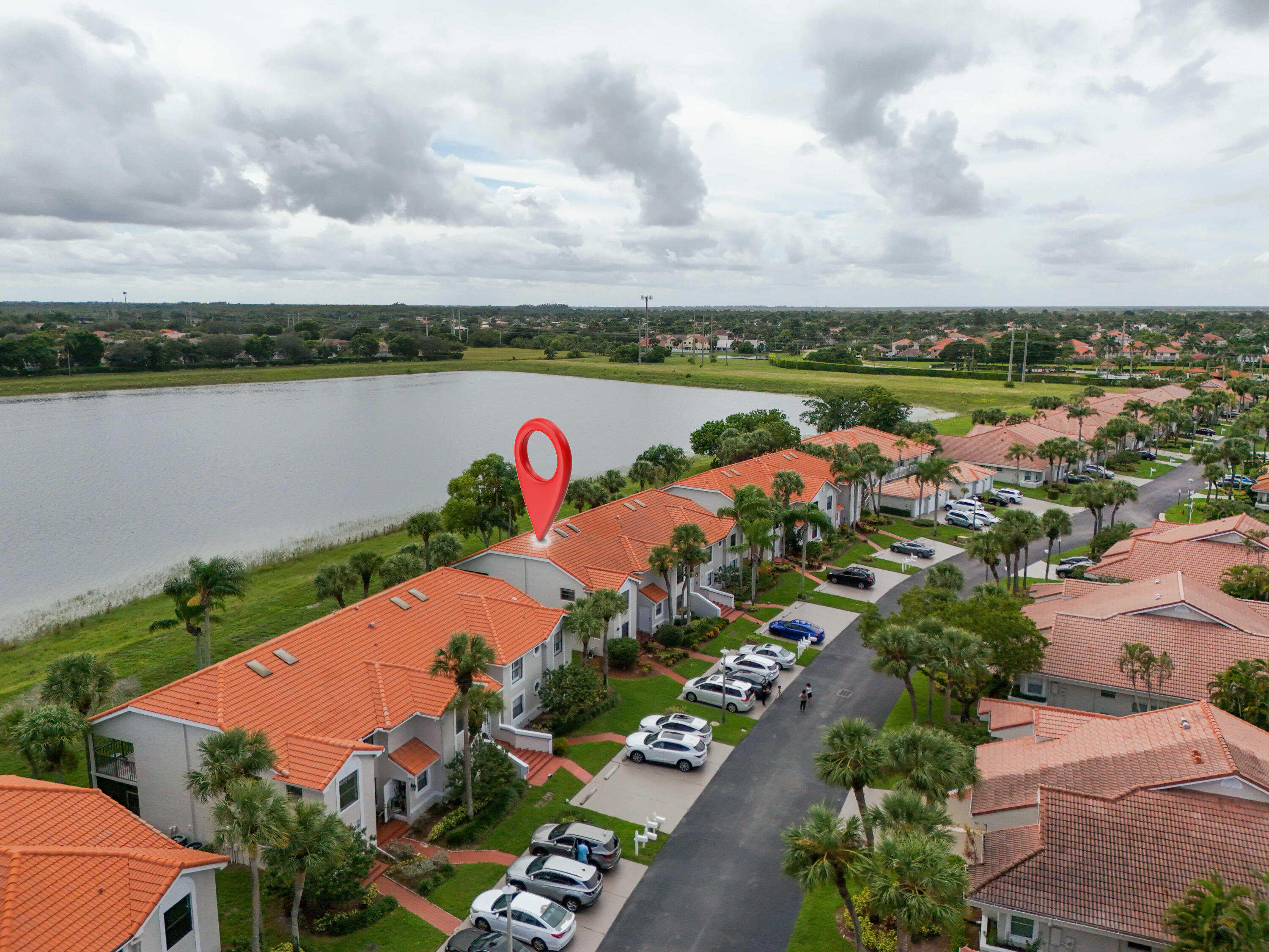 10910 Lakemore Lane, Unit 201 Boca Raton, FL 33498 - Photo 57 of 67 an aerial view of a city with lots of residential buildings lake and ocean view