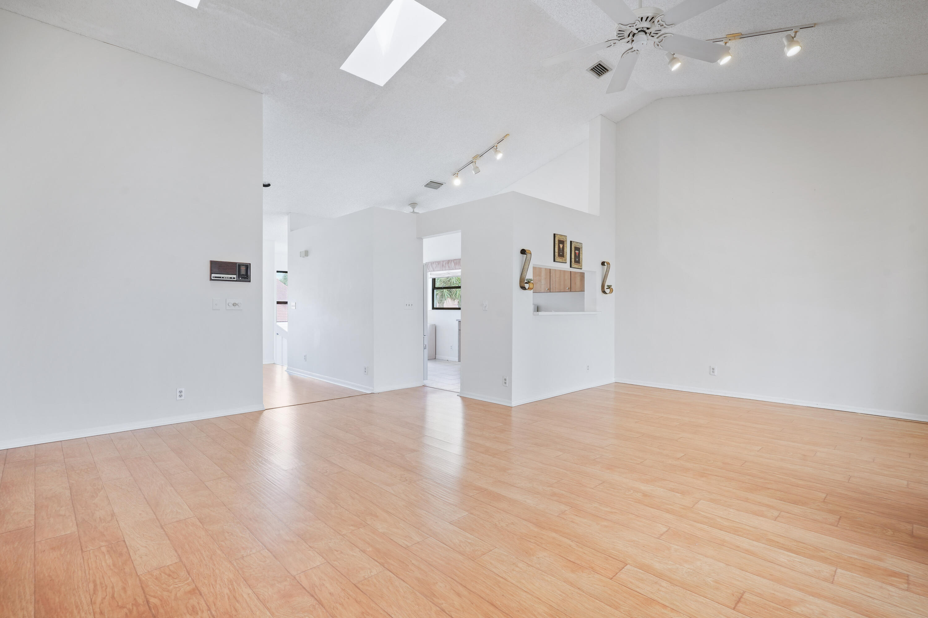 10910 Lakemore Lane, Unit 201 Boca Raton, FL 33498 - Photo 8 of 67 an empty room with wooden floor and windows