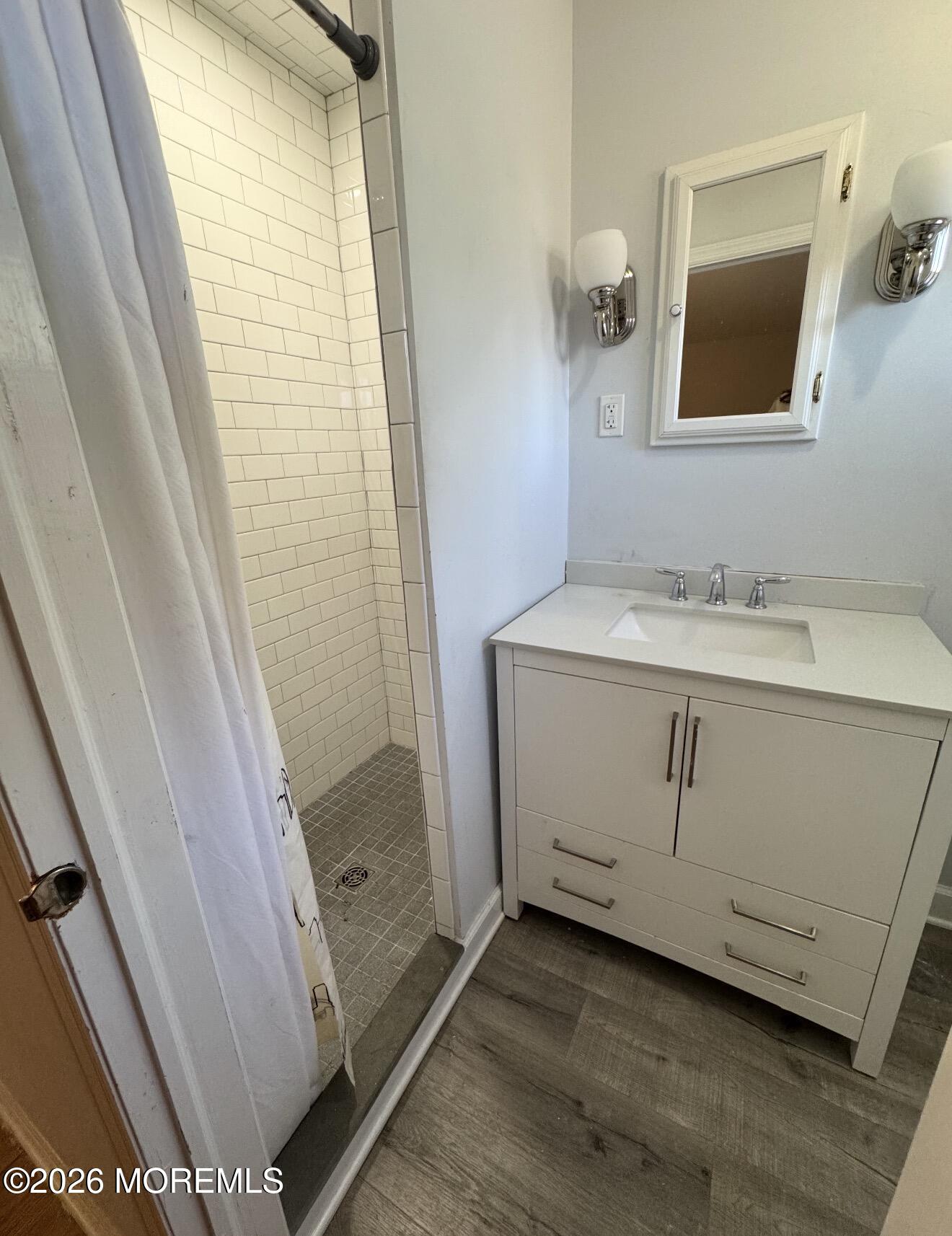 33 Parker Road West Long Branch, NJ 07764 - Photo 11 of 13 a bathroom with a sink a mirror and shower