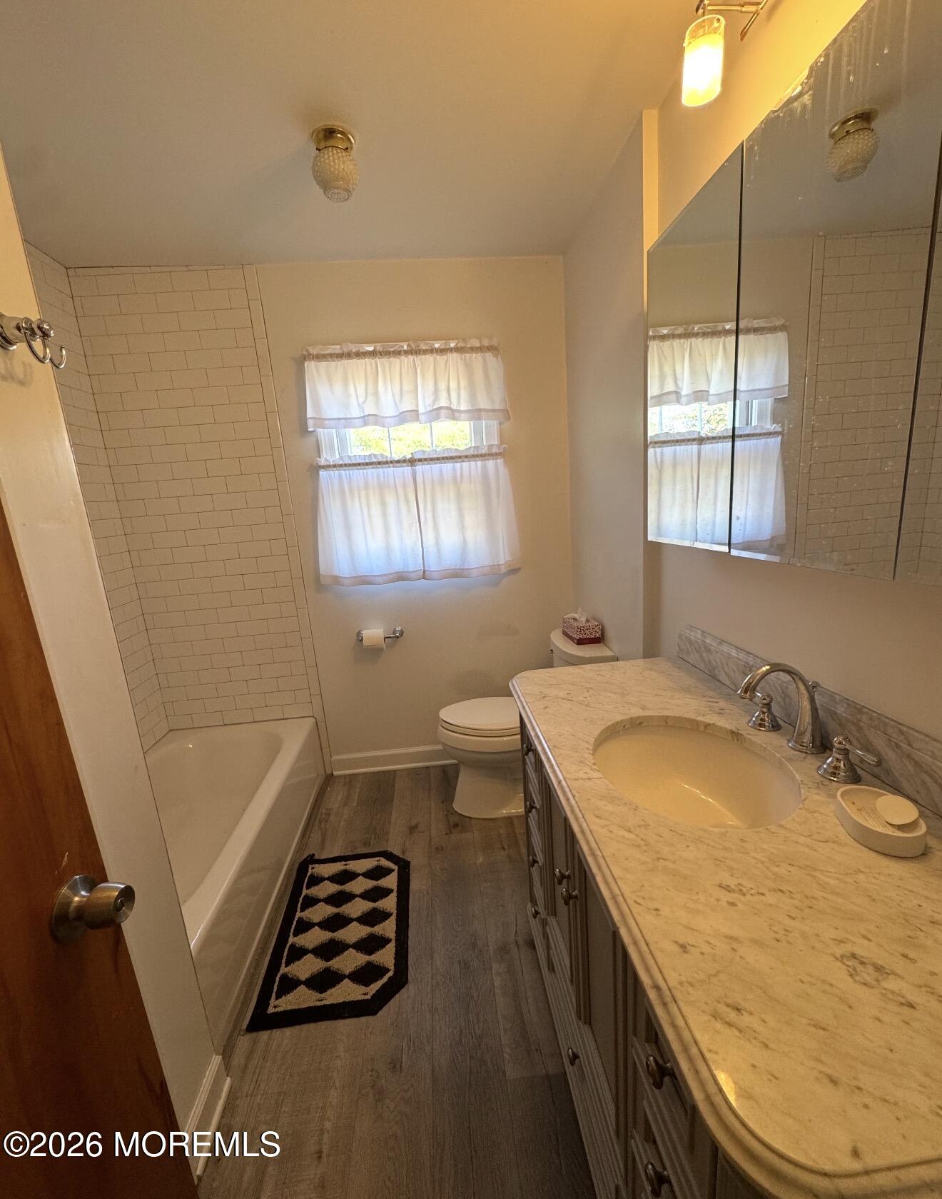 33 Parker Road West Long Branch, NJ 07764 - Photo 9 of 13 a bathroom with a granite countertop sink a toilet a window and vanity