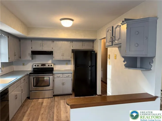 a kitchen with a sink window and cabinets