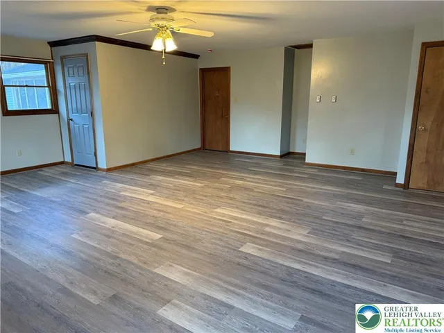 an empty room with windows and closet