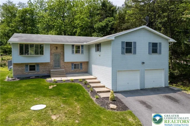 an aerial view of a house with a yard