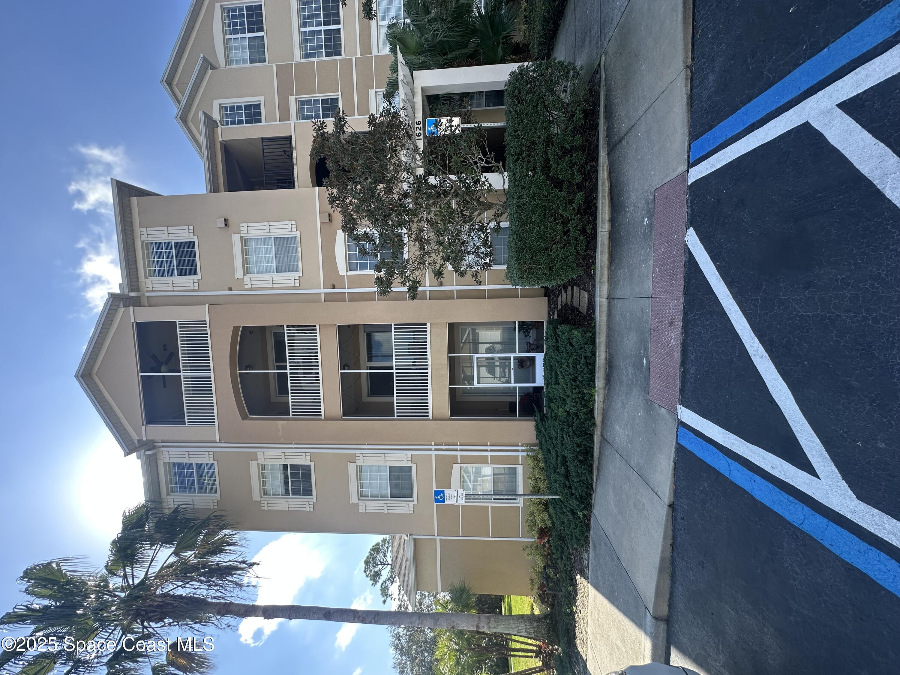 1626 Peregrine Circle, Unit 305 Rockledge, FL 32955 - Photo 1 of 20 a front view of a house with a yard