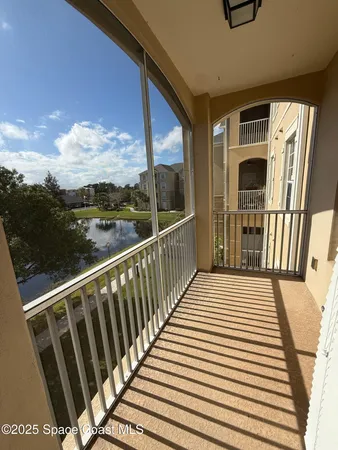 a view of a balcony with wooden floor
