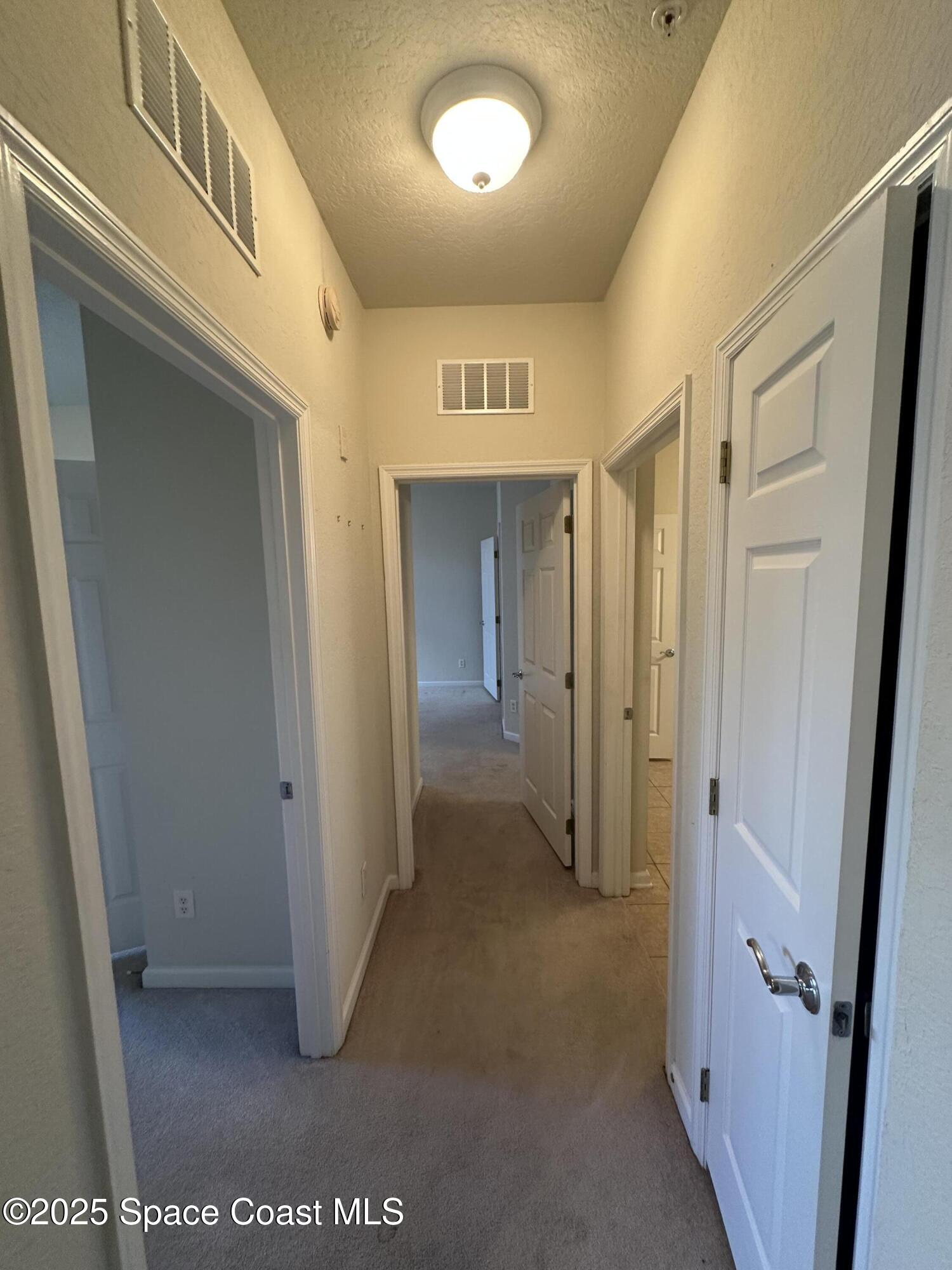 1626 Peregrine Circle, Unit 305 Rockledge, FL 32955 - Photo 11 of 20 a view of hallway with a bathroom