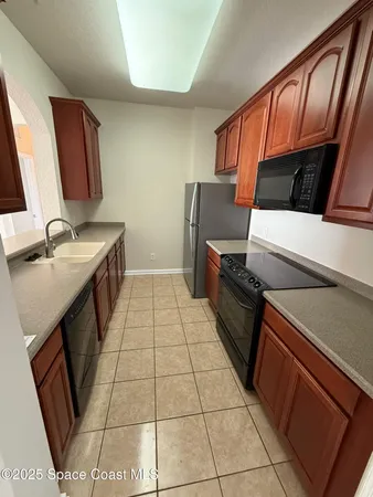 a kitchen with a sink a stove and a microwave