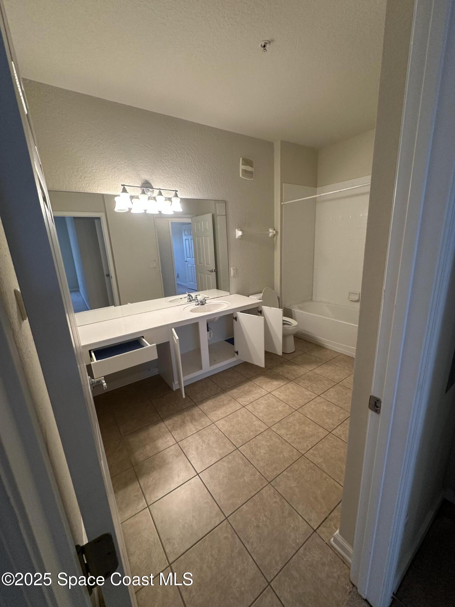 1626 Peregrine Circle, Unit 305 Rockledge, FL 32955 - Photo 15 of 20 a bathroom with a sink and a mirror