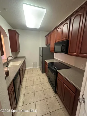 a kitchen with stainless steel appliances a stove a sink and a refrigerator