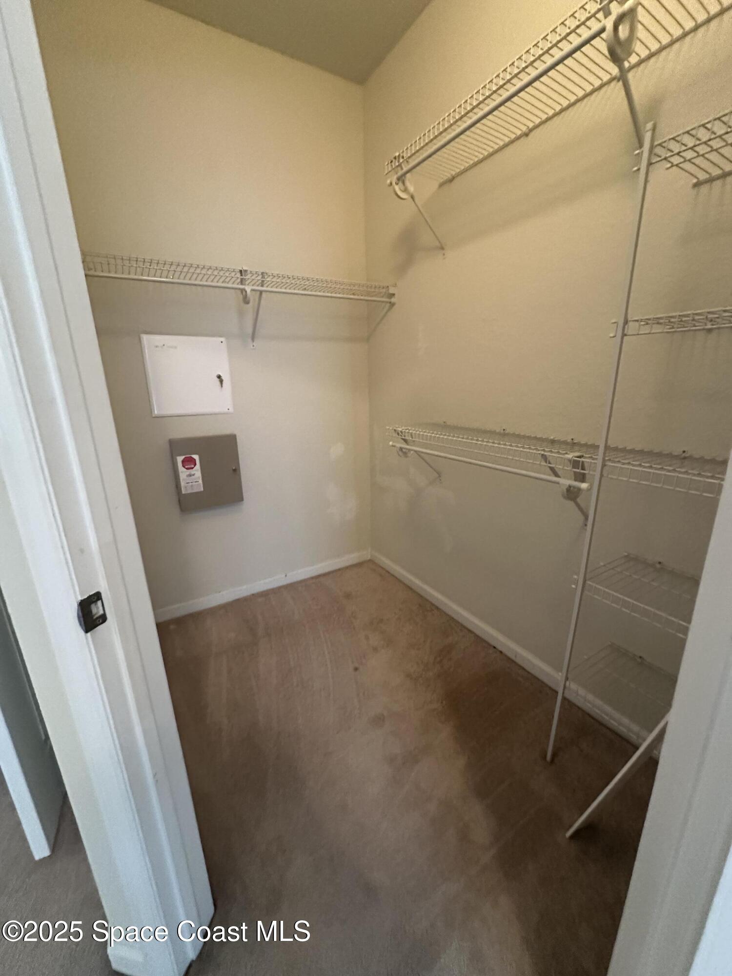 1626 Peregrine Circle, Unit 305 Rockledge, FL 32955 - Photo 8 of 20 a view of a room with racks on the wall