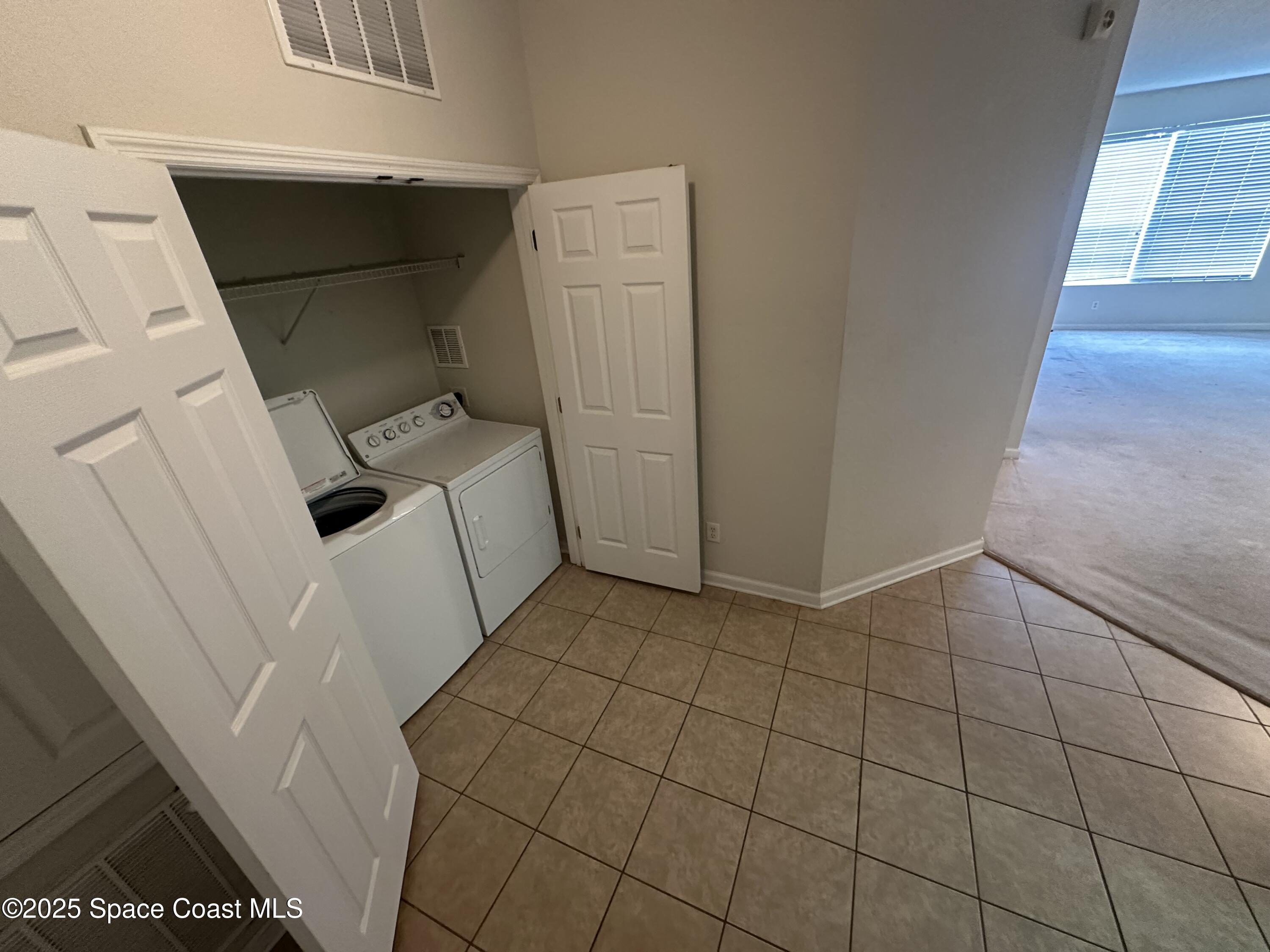 1626 Peregrine Circle, Unit 305 Rockledge, FL 32955 - Photo 10 of 20 a utility room with dryer and washer