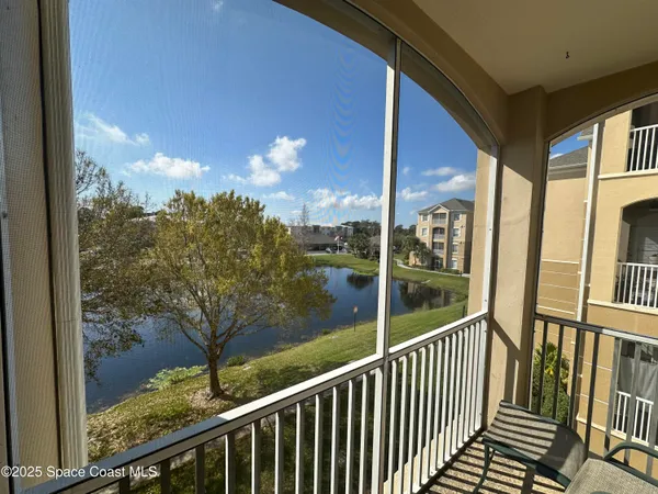 a view of a balcony with floor to ceiling window wooden floor and fence