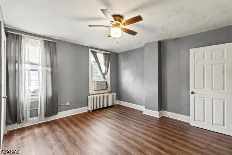 636 Elizabeth Street Beverly, NJ 08010 - Photo 11 of 15 an empty room with wooden floor and windows