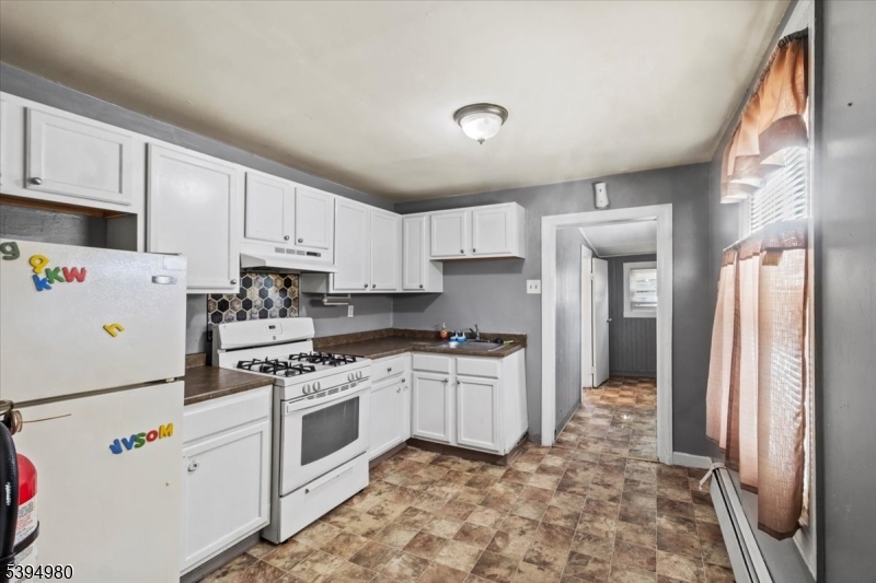 636 Elizabeth Street Beverly, NJ 08010 - Photo 13 of 15 a kitchen with white cabinets and white appliances