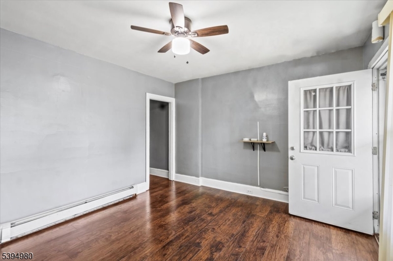 636 Elizabeth Street Beverly, NJ 08010 - Photo 2 of 15 wooden floor in an empty room with a window