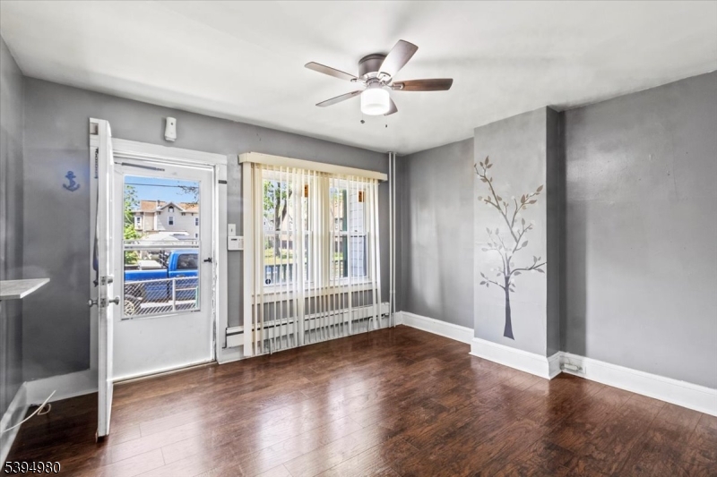 636 Elizabeth Street Beverly, NJ 08010 - Photo 3 of 15 wooden floor in an empty room with a window