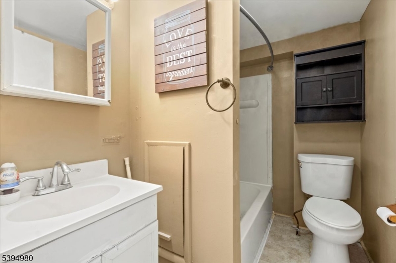 636 Elizabeth Street Beverly, NJ 08010 - Photo 9 of 15 a white toilet sitting next to a bathroom sink