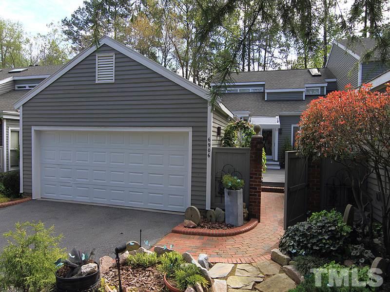 6906 Hunters Way Raleigh, NC 27615 - Photo 1 of 25 a front view of a house with a yard