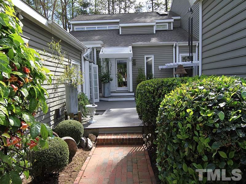 6906 Hunters Way Raleigh, NC 27615 - Photo 2 of 25 a house with potted plants in front of it