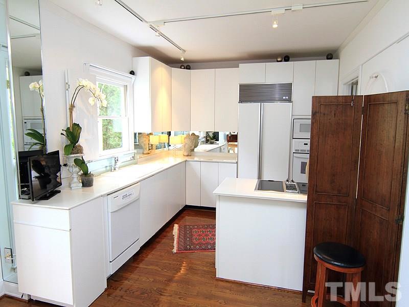 6906 Hunters Way Raleigh, NC 27615 - Photo 14 of 25 a kitchen with a sink stove and refrigerator