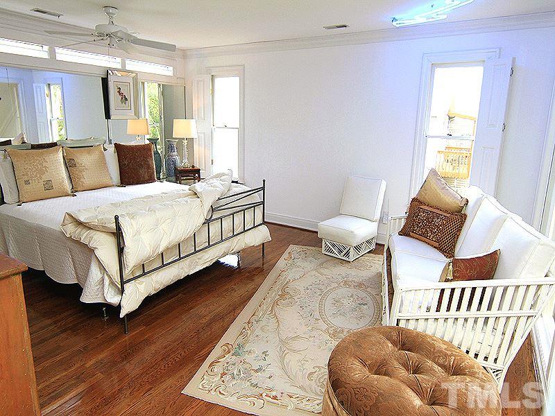 6906 Hunters Way Raleigh, NC 27615 - Photo 19 of 25 a bedroom with a bed and window