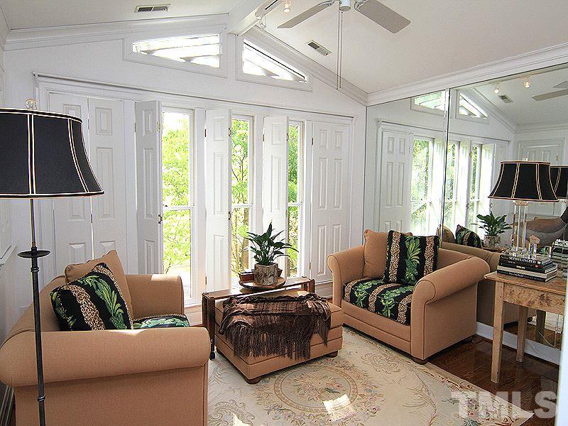 6906 Hunters Way Raleigh, NC 27615 - Photo 23 of 25 a living room with furniture and a flat screen tv