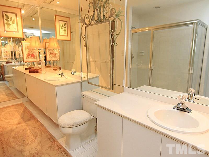 6906 Hunters Way Raleigh, NC 27615 - Photo 24 of 25 a bathroom with a sink a toilet and a mirror