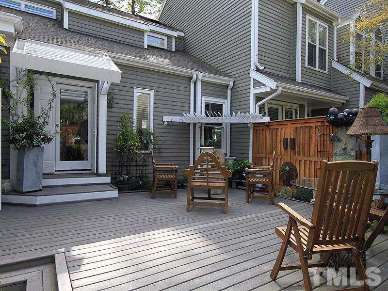 6906 Hunters Way Raleigh, NC 27615 - Photo 4 of 25 a view of a house with a chairs on wooden deck