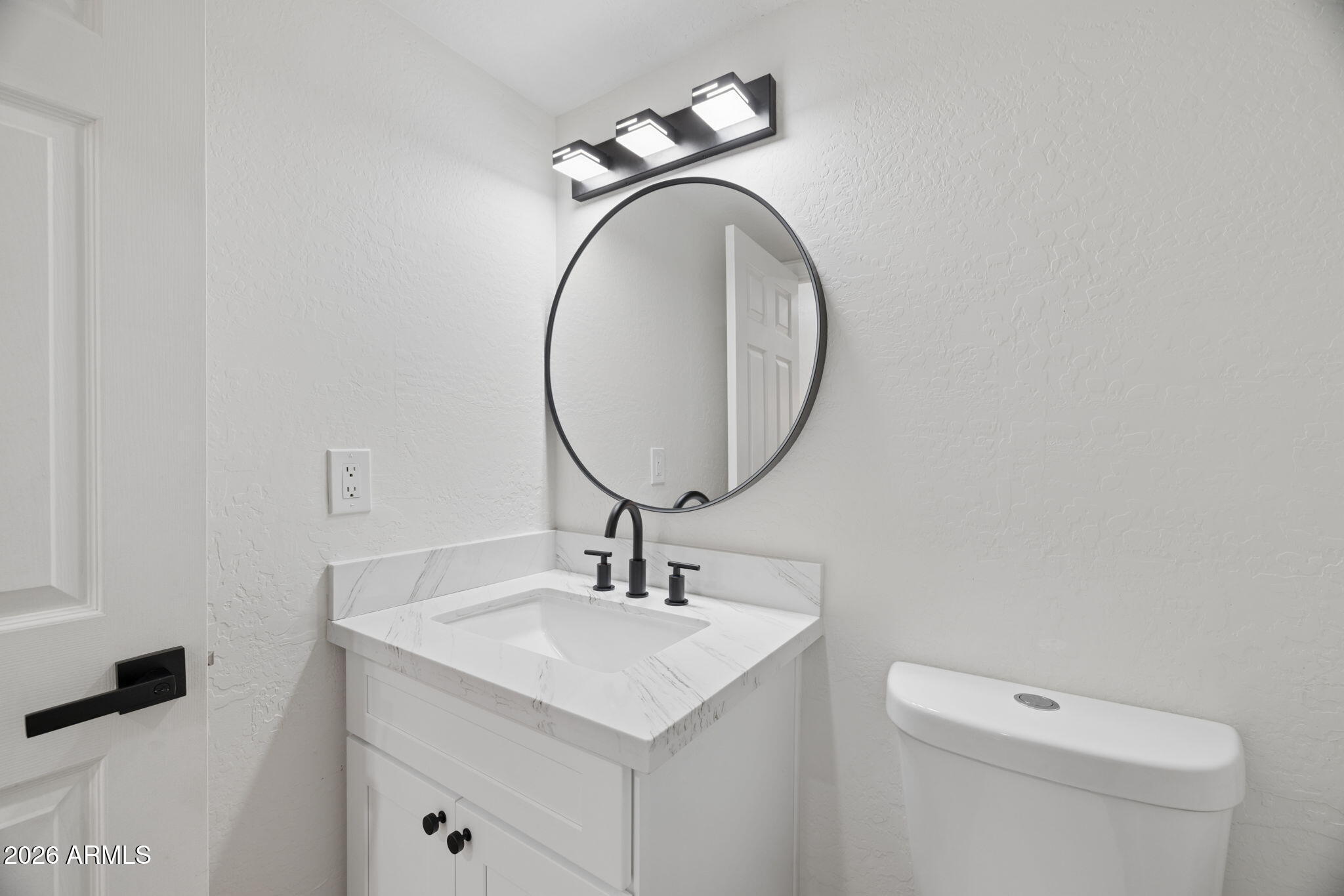 16409 South 33rd Street Phoenix, AZ 85048 - Photo 22 of 61 a bathroom with a toilet a sink and mirror