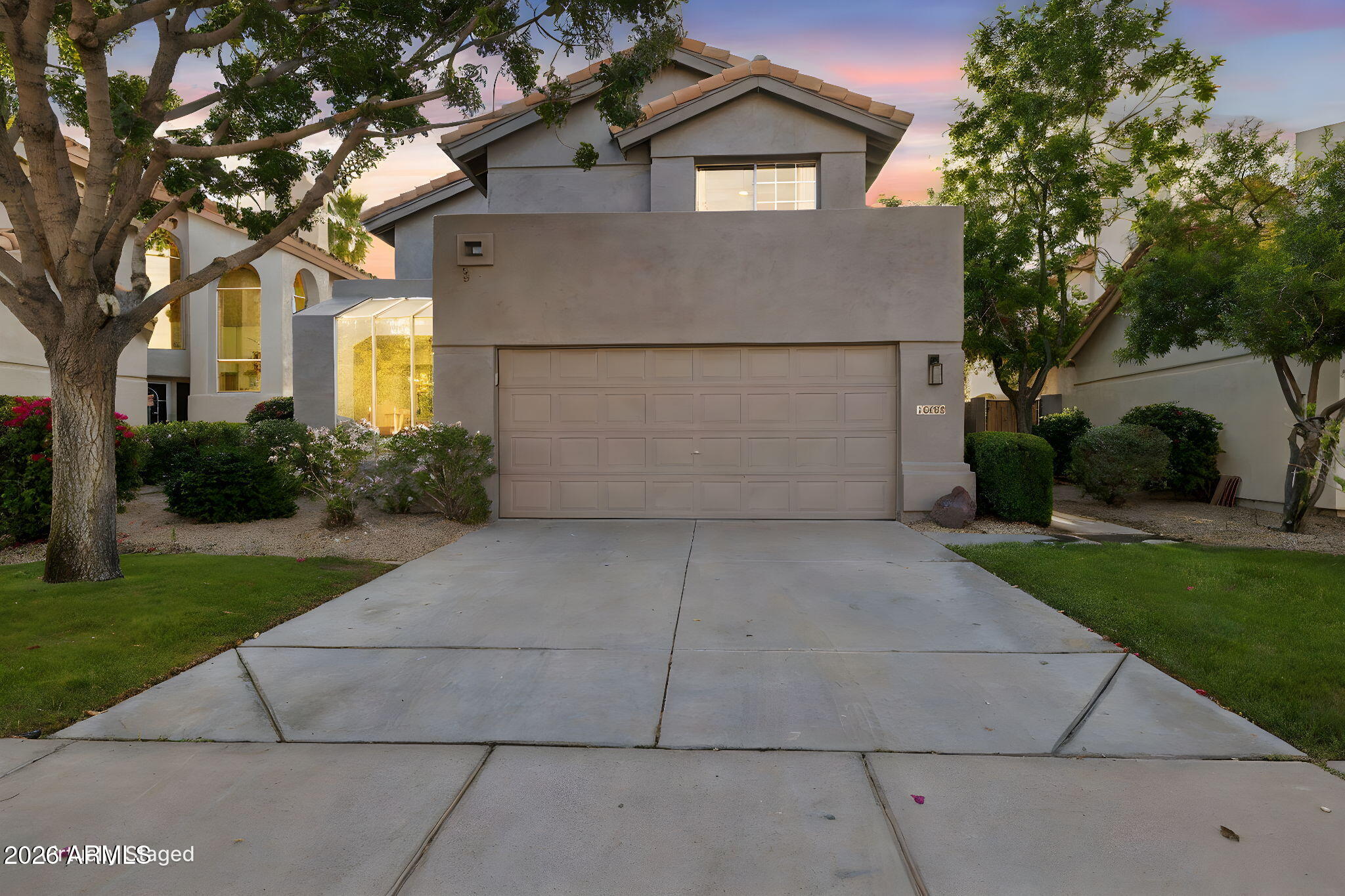 16409 South 33rd Street Phoenix, AZ 85048 - Photo 2 of 61 a view of a white house with a yard and plants