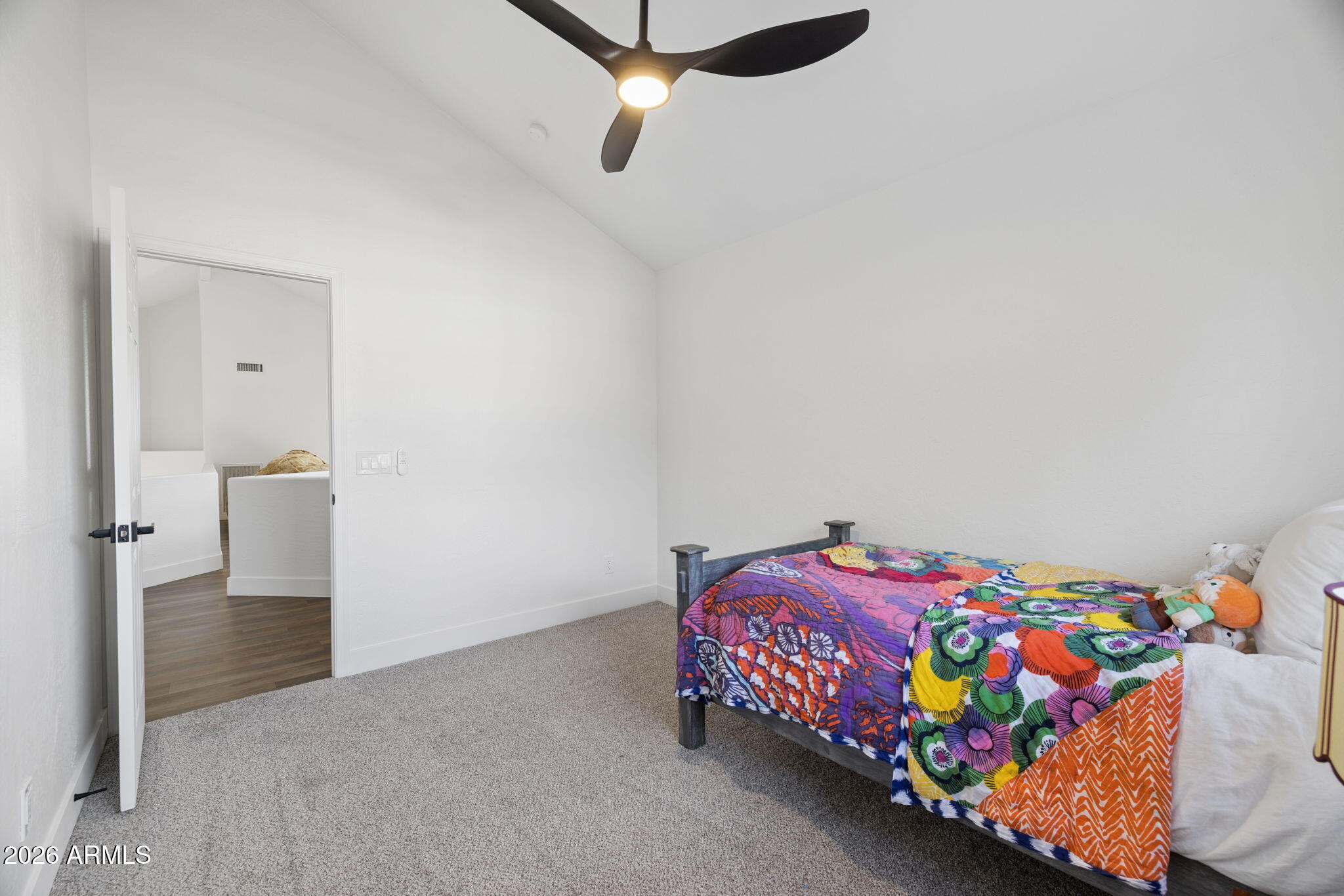 16409 South 33rd Street Phoenix, AZ 85048 - Photo 40 of 61 a bedroom with a bed and a chandelier