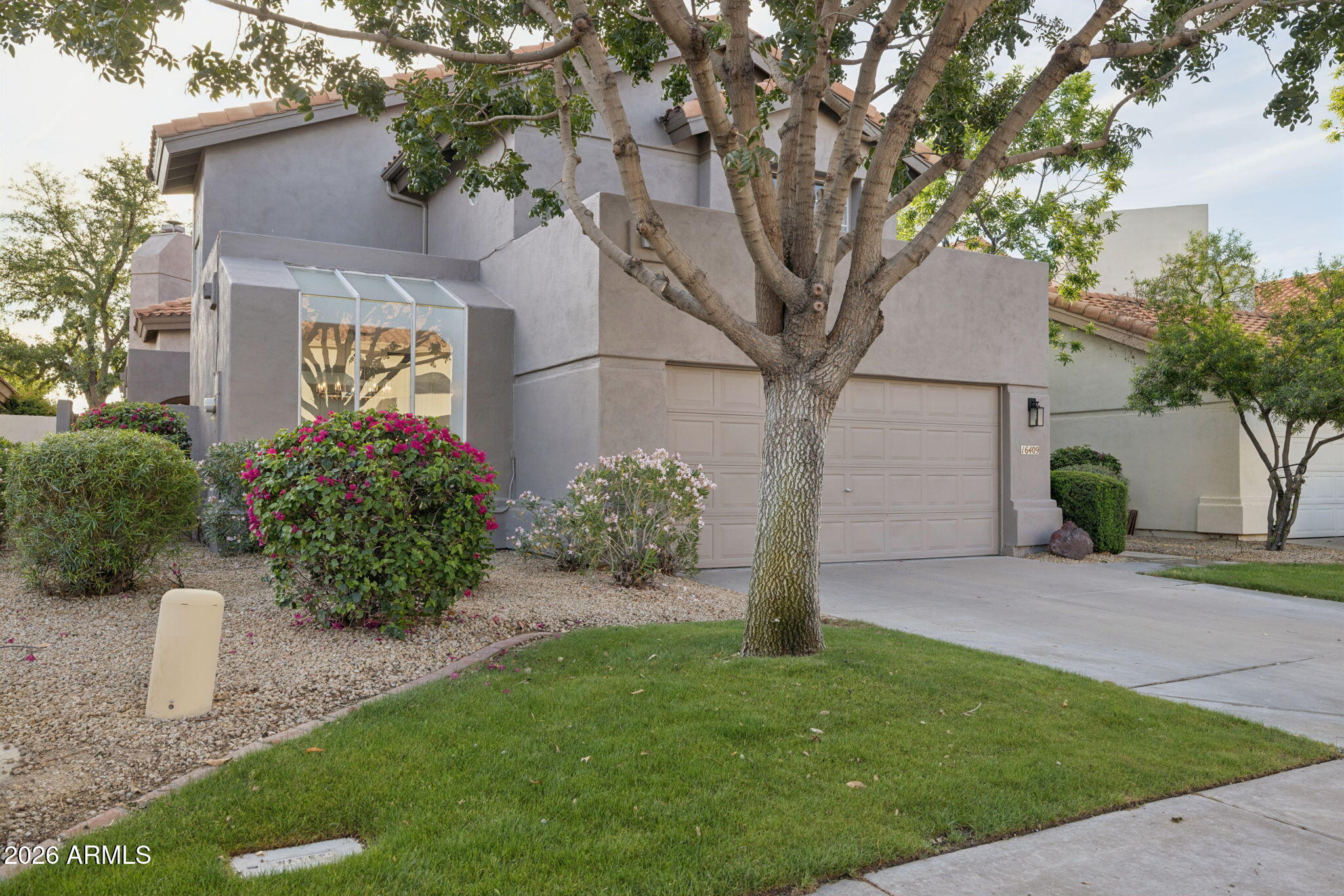 16409 South 33rd Street Phoenix, AZ 85048 - Photo 4 of 61 a front view of a house with a garden and yard