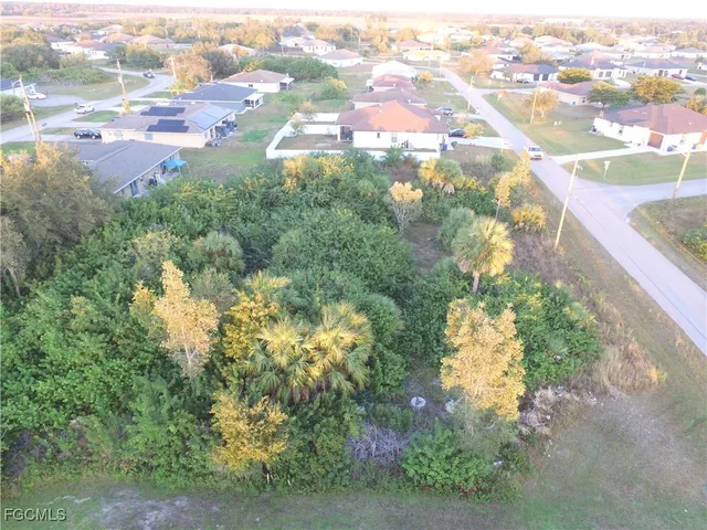 an aerial view of residential houses with yard