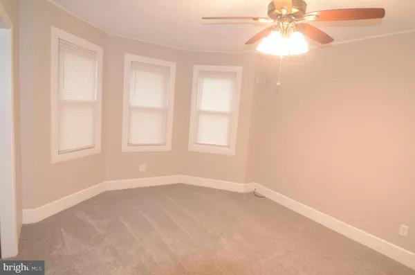 an empty room with a empty space and a ceiling fan