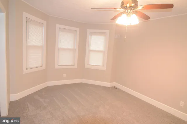 an empty room with a empty space and a ceiling fan