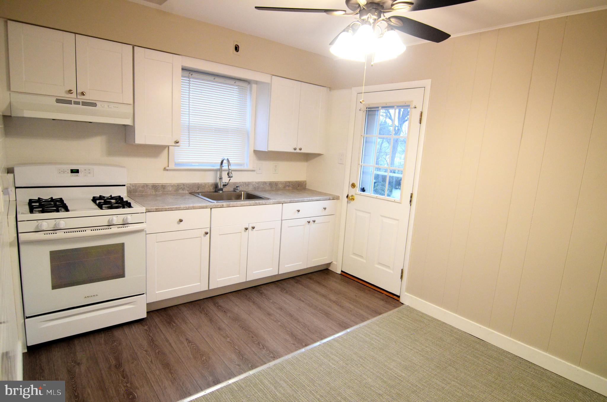 219 9th Avenue, Unit B Haddon Heights, NJ 08035 - Photo 2 of 22 a kitchen with a sink cabinets and window