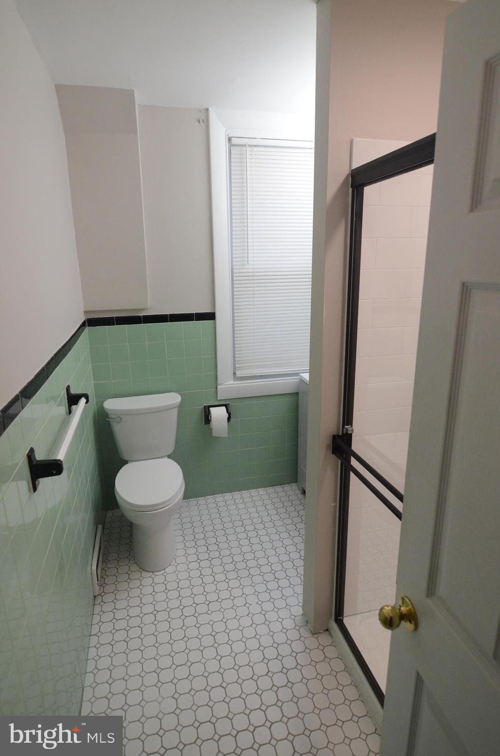 219 9th Avenue, Unit B Haddon Heights, NJ 08035 - Photo 5 of 22 a bathroom with a toilet and a mirror
