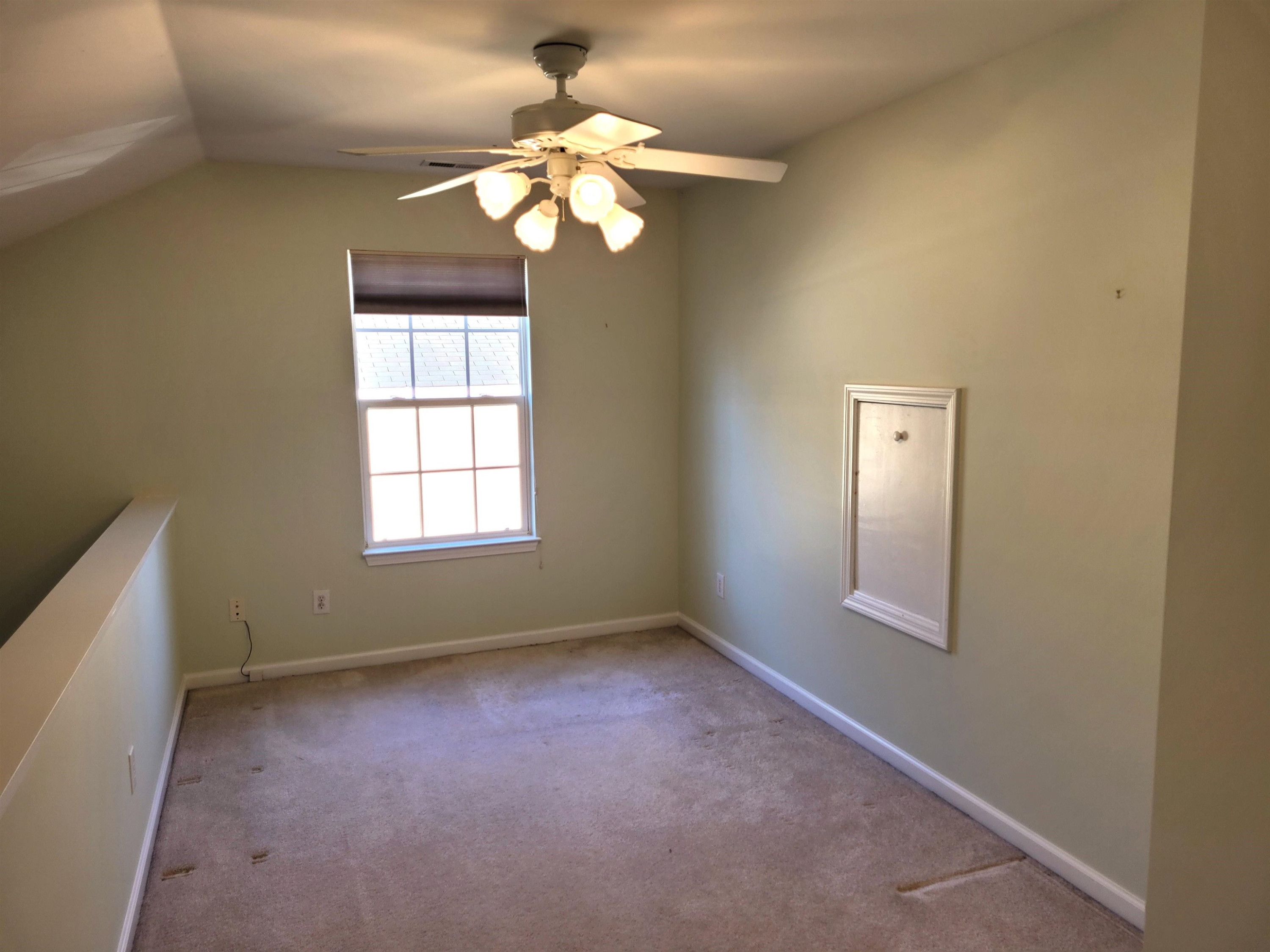 7 Calaveras Court Durham, NC 27713 - Photo 21 of 30 an empty room with a chandelier fan and windows