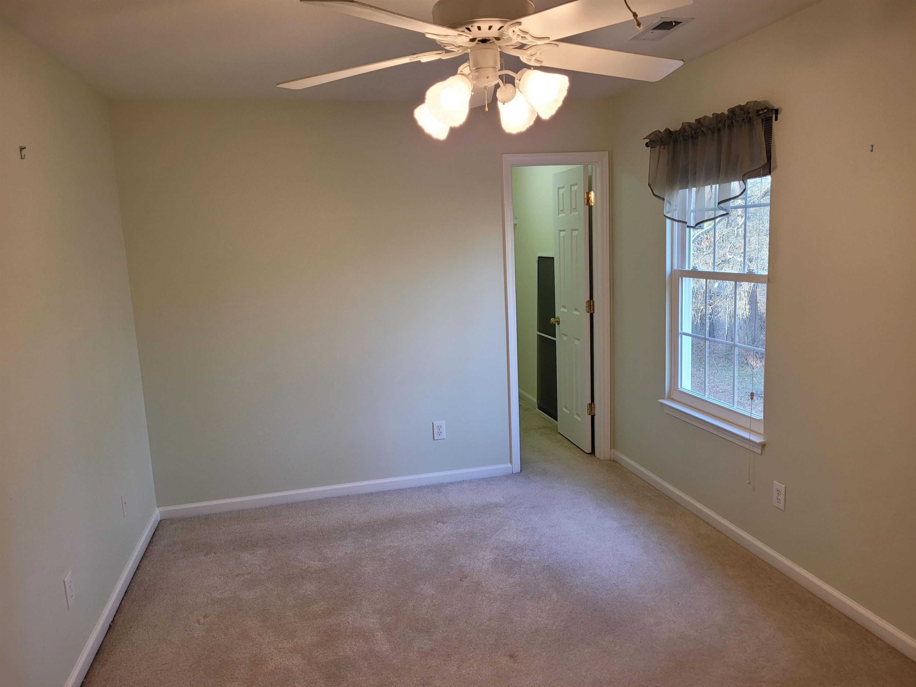 7 Calaveras Court Durham, NC 27713 - Photo 22 of 30 an empty room with chandelier fan and windows