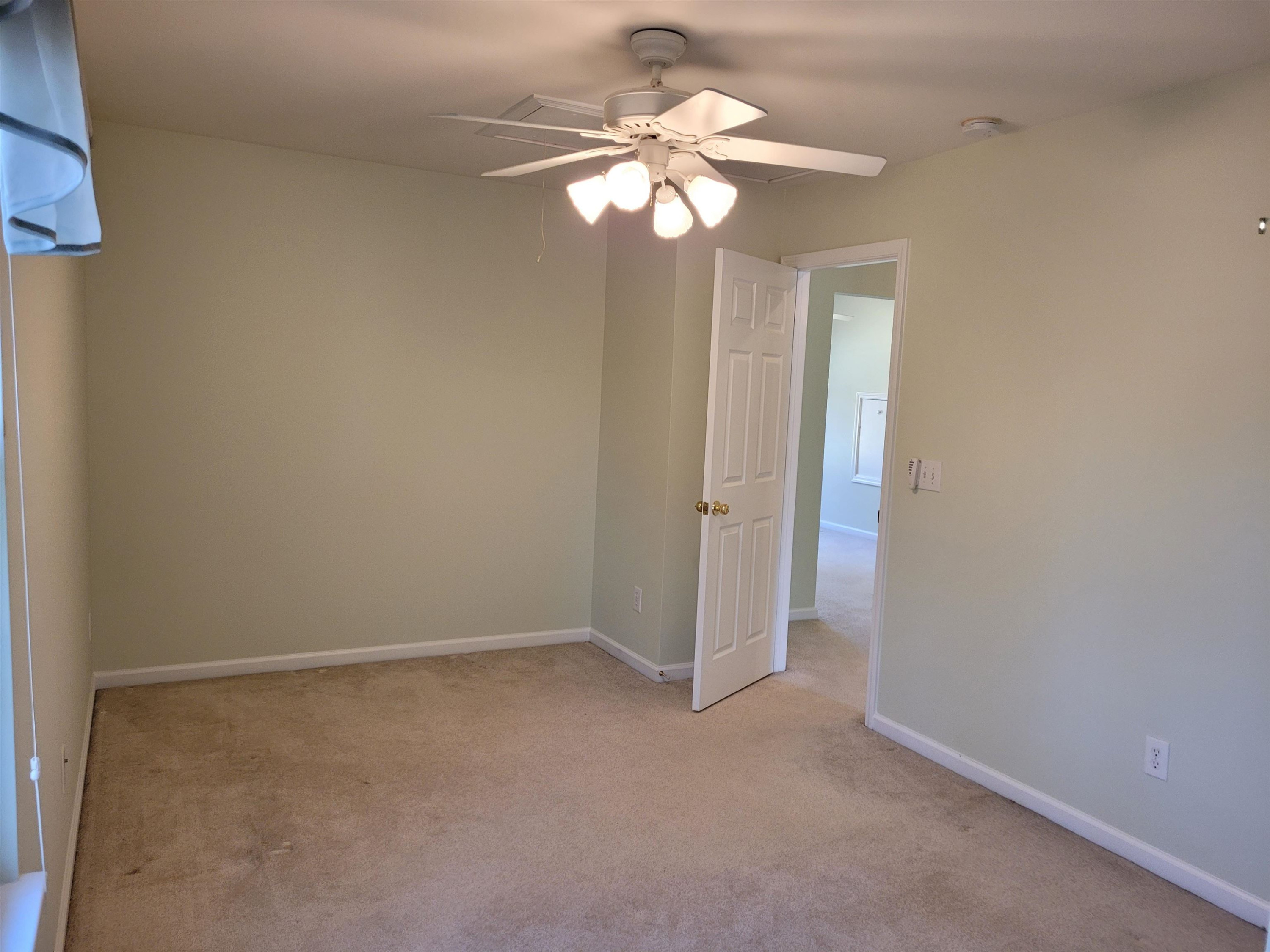 7 Calaveras Court Durham, NC 27713 - Photo 23 of 30 an empty room with a chandelier fan and windows